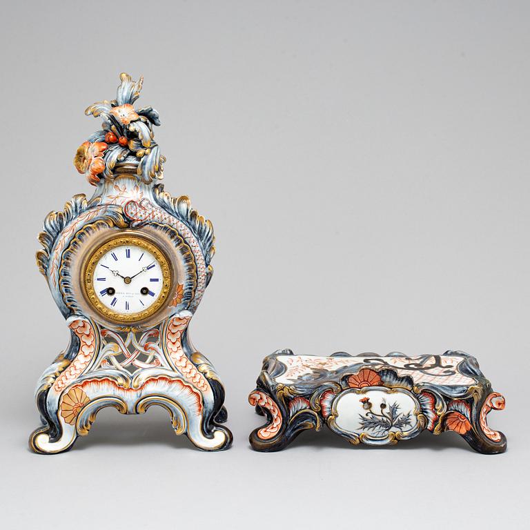 A new rococo creamware bracket clock, after Meissen model, early 20th century.