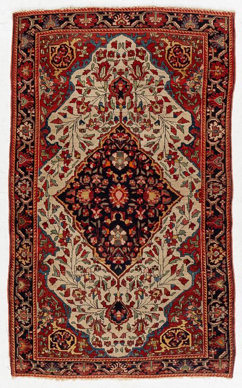 An antique Sarouk rug Western Iran, c 160 x 96 cm.