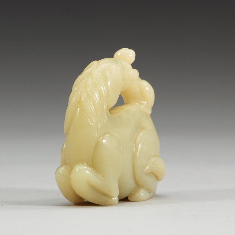 A nephrite figure of a reclining horse with a monkey, China.