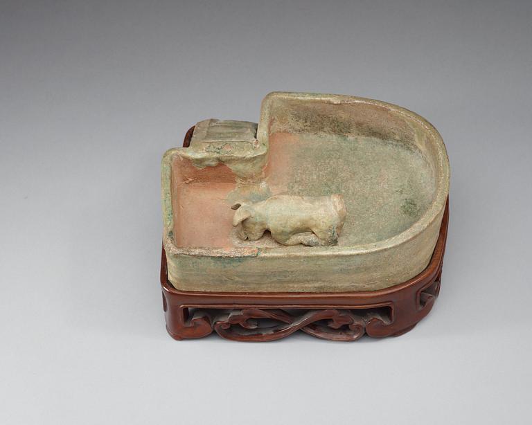 A green glazed pottery model of a pig sty, Han dynasty  (206 BC–AD 220).
