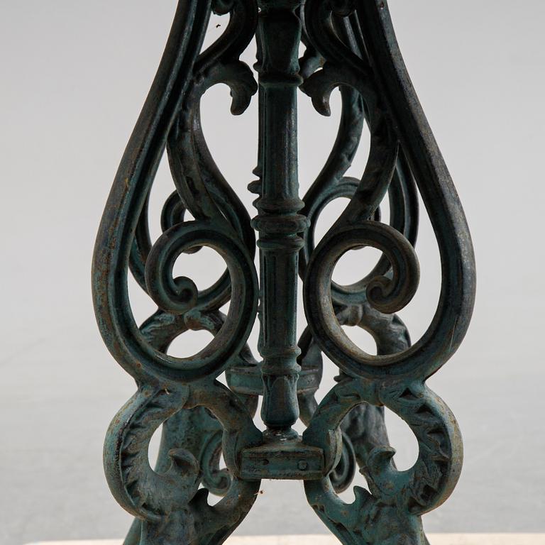 A early 20th Century cast iron garden table with later concrete top.