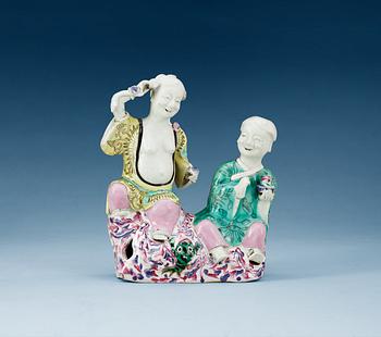 A famille rose figure of two boys, Qing dynasty, ca 1800.