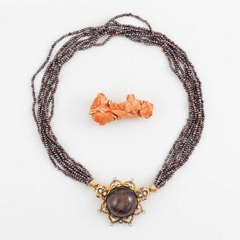 Multi-strand pearl necklace with two clasps set with carved coral, cabochon-cut tourmaline, and brilliant-cut diamonds.
