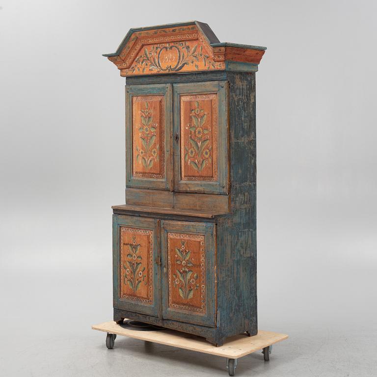A painted cabinet, dated 1825.