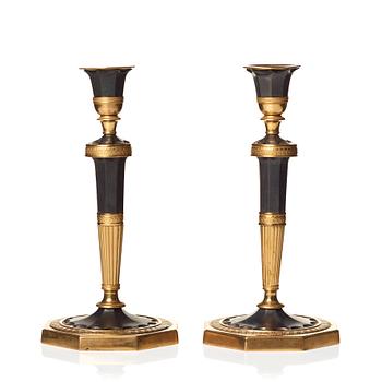 128. A pair of Directoire candlesticks.
