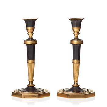 128. A pair of Directoire candlesticks.