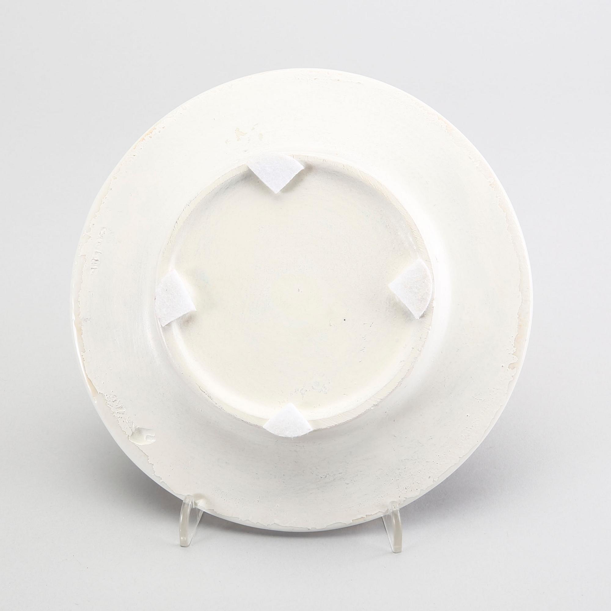 A st of three Piero Fornasetti porcelain plates.