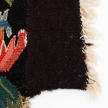 A fragment of a 19th century carrige cushion, "Urnor och par", tapestry weave, ca 50 x 45-55 cm.