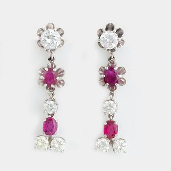 Oval faceted ruby and brilliant-cut diamond earrings.