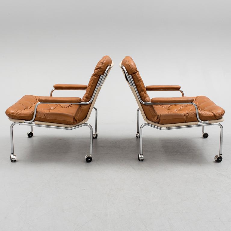 A pair of leather upholstered easy chairs, 1960's/70's.