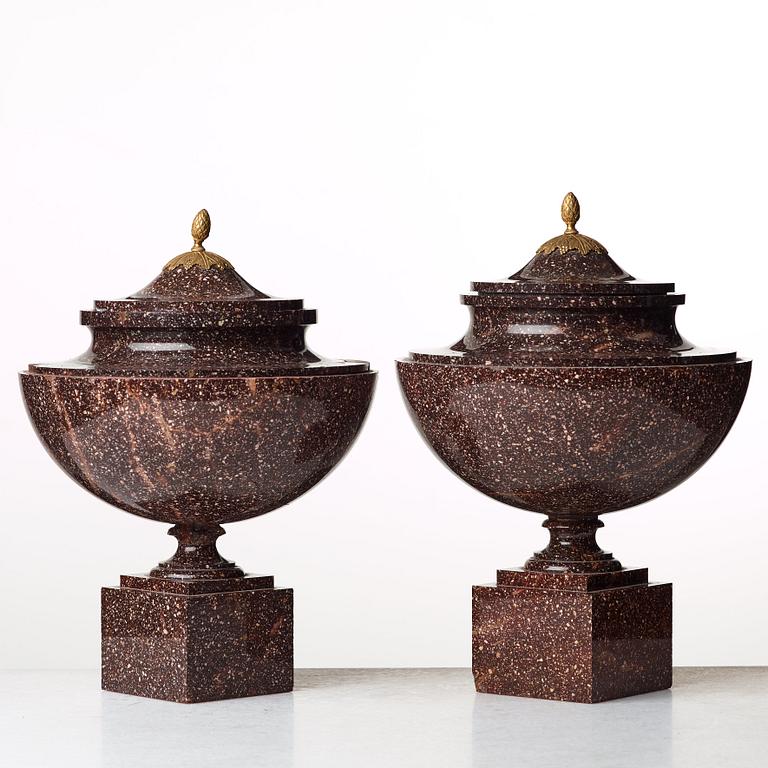 A pair of late Gustavian early 19th century porphyry urns with cover.