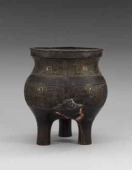 A large archaistic bronze tripod censer, probably Ming dynasty (1368-1644).