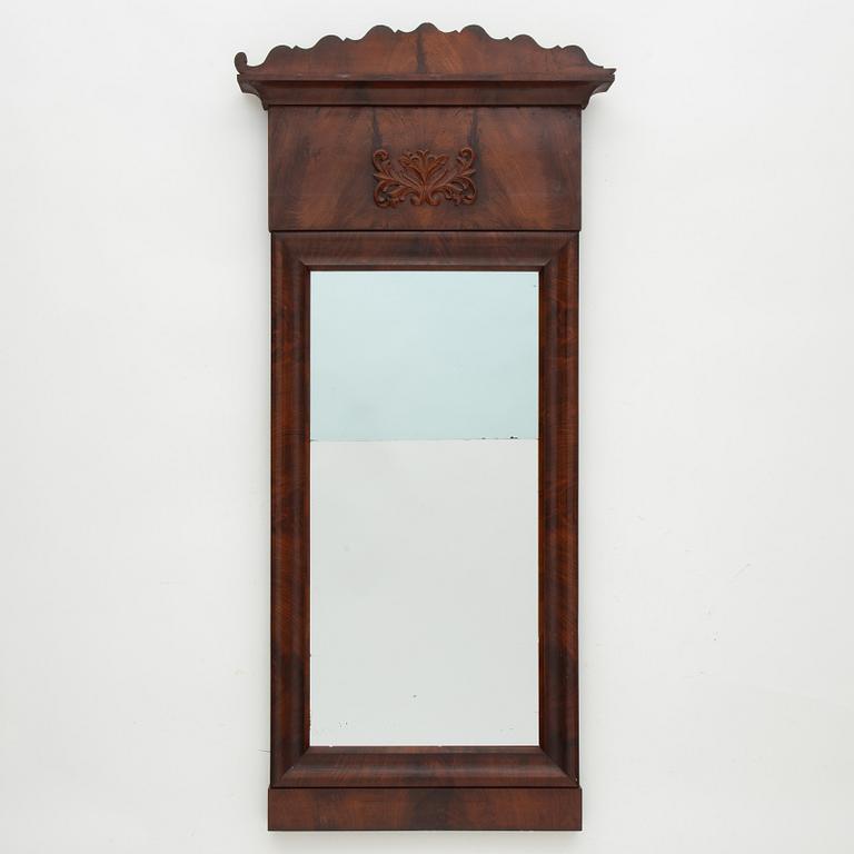 A Swedish Empire mirror with a console table, first half of the 19th Century.