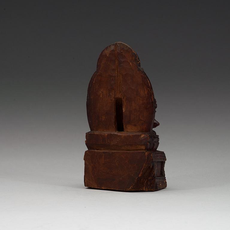 A carved wooden figure on Ganesha on a throne, Nepal, 19th Century or older.