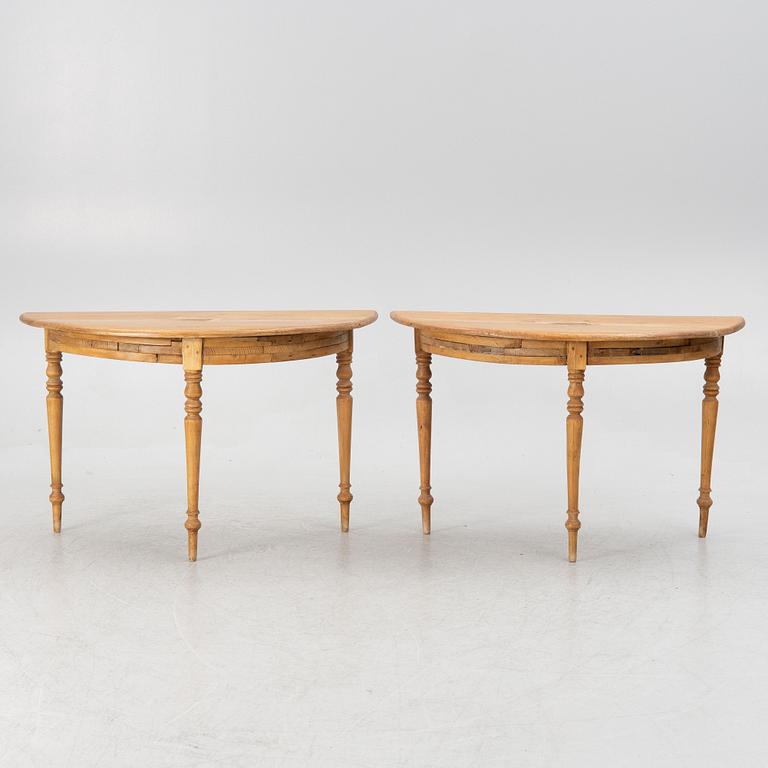 A round pine dining table/a pair of crescent shaped tables, Sweden, 19th century.
