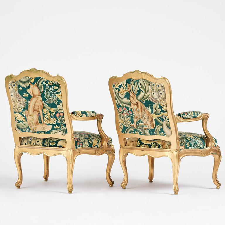 A pair of Louis XV-style giltwood fauteuils, late 19th century.
