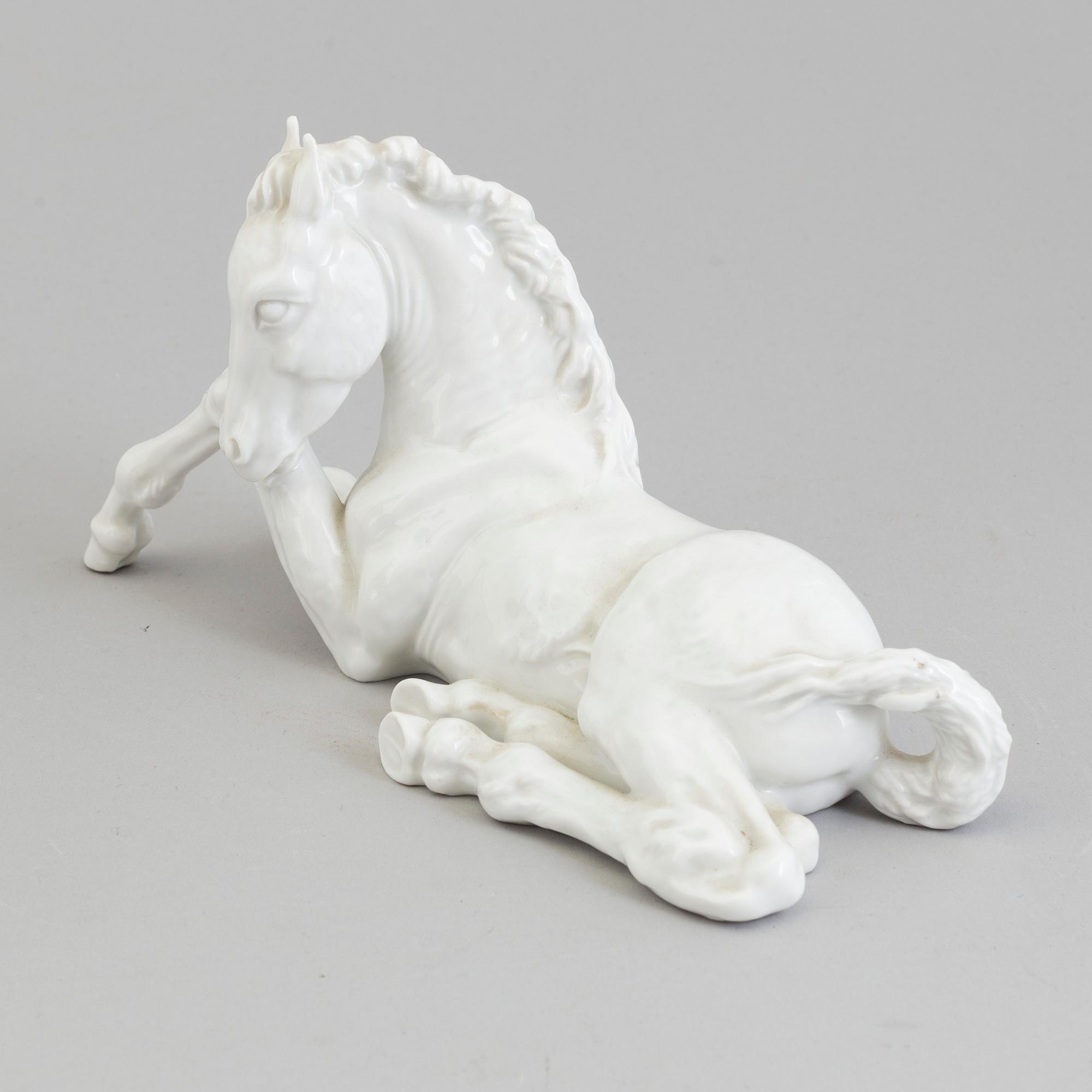 A white glazed porcelain figure of a reclining foal, Meissen, 1950's.