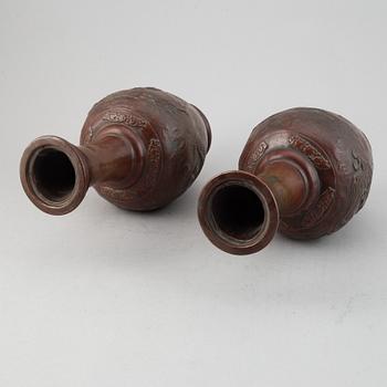 A pair of Japanese copper alloy temple vases, Meiji period (1868-1912).