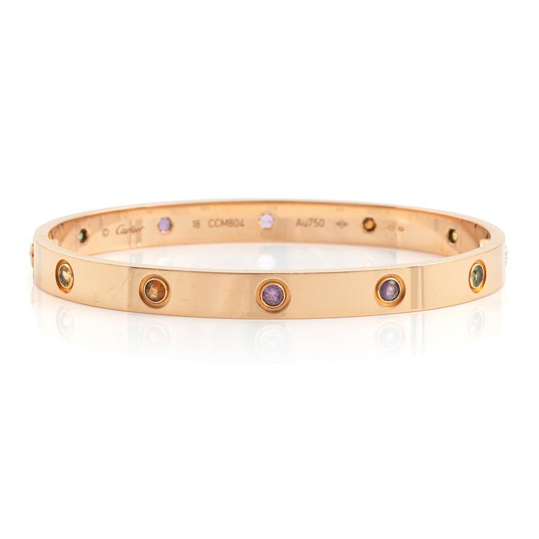 A Cartier "Love" bracelet in 18K rose gold set with colored stones.