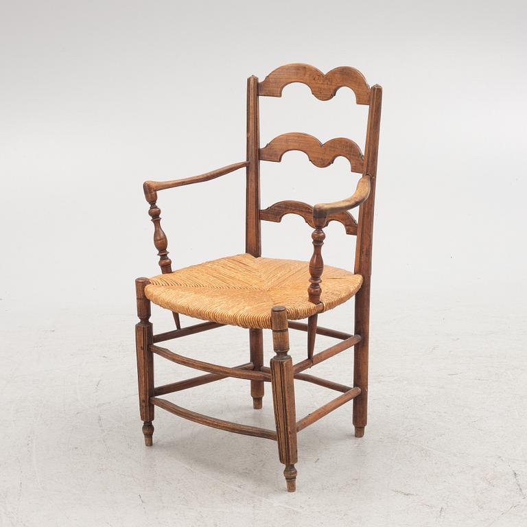 A French walnut open armchair, first part 19th century.