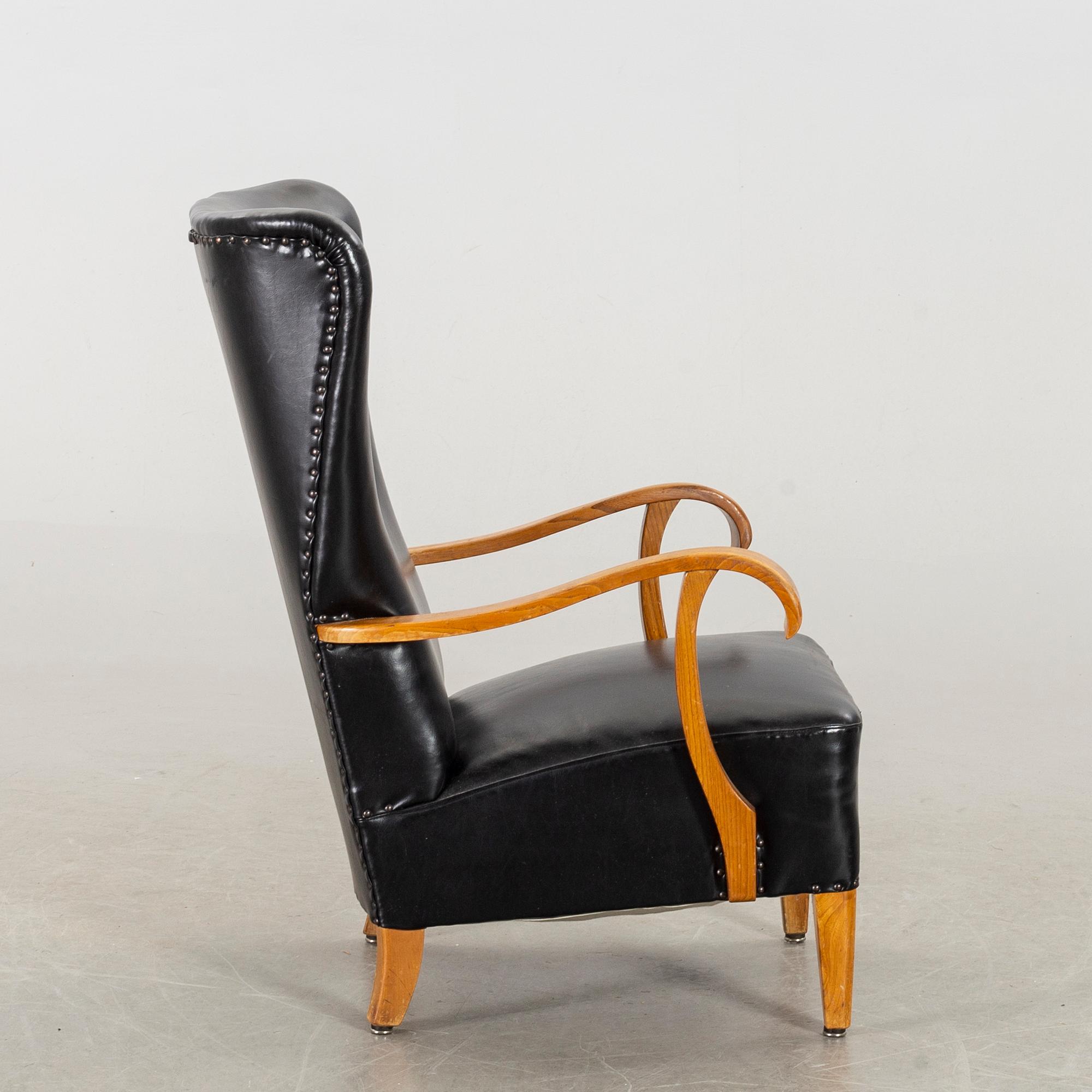 A 1940's - 50's easy chair in black leather, Scandinavian.