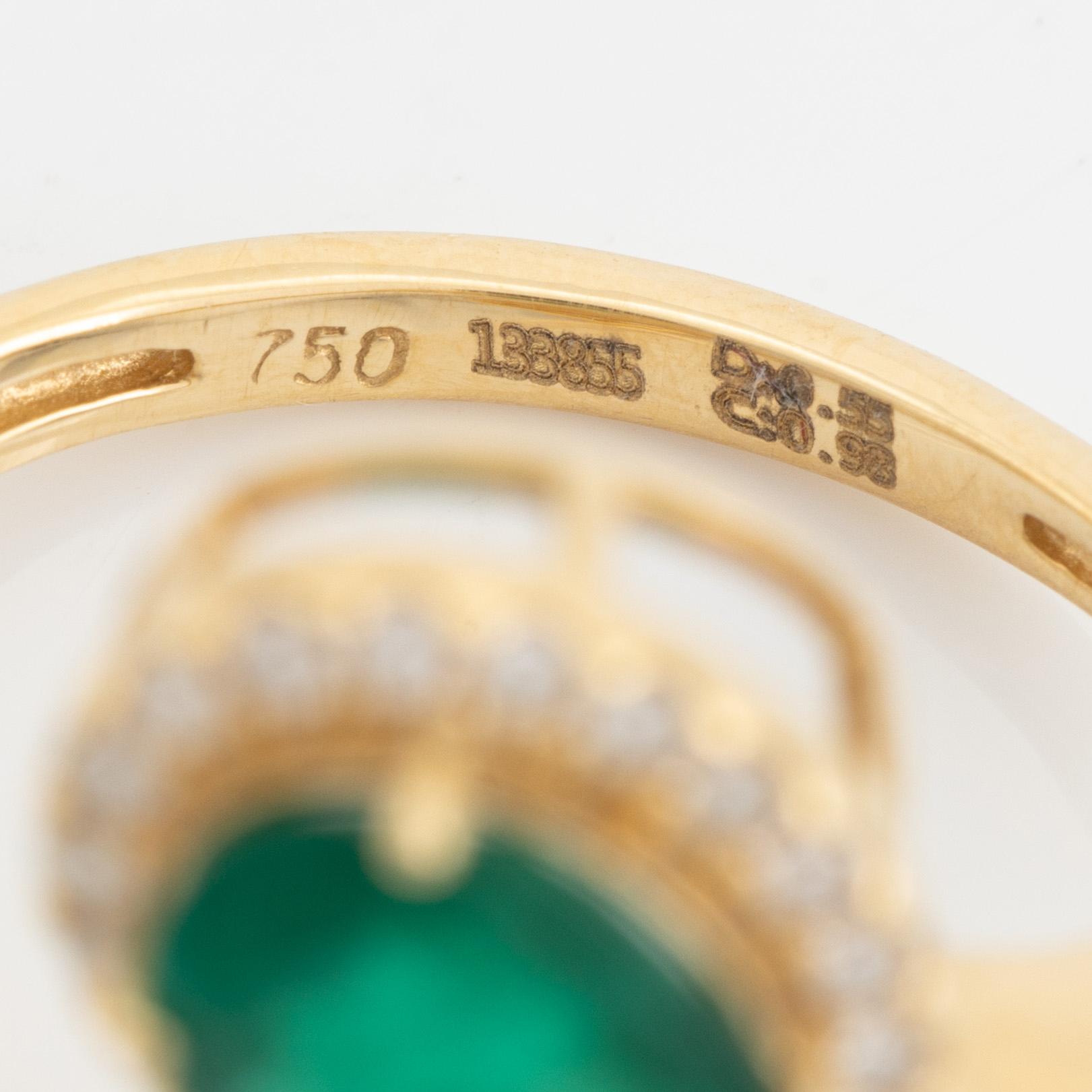Emerald and diamond cross over ring.