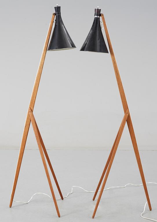 A pair of Uno and Östen Kristiansson teak tripod floor lamps with black shades. Luxus, Sweden 1950's.