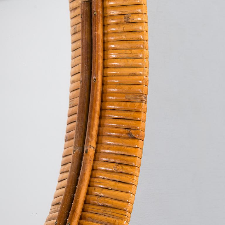 A mid-20th-century rattan wall mirror.