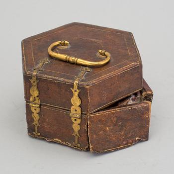A gilded brass baroque travel clock from around 1700, with original case.