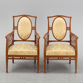 A mahogany sofa, with two armchairs and a round table, early 20th Century.