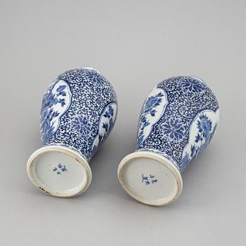 A pair of blue and white vases, Qing dynasty, late 19th century, with a Kangxi mark to the base.