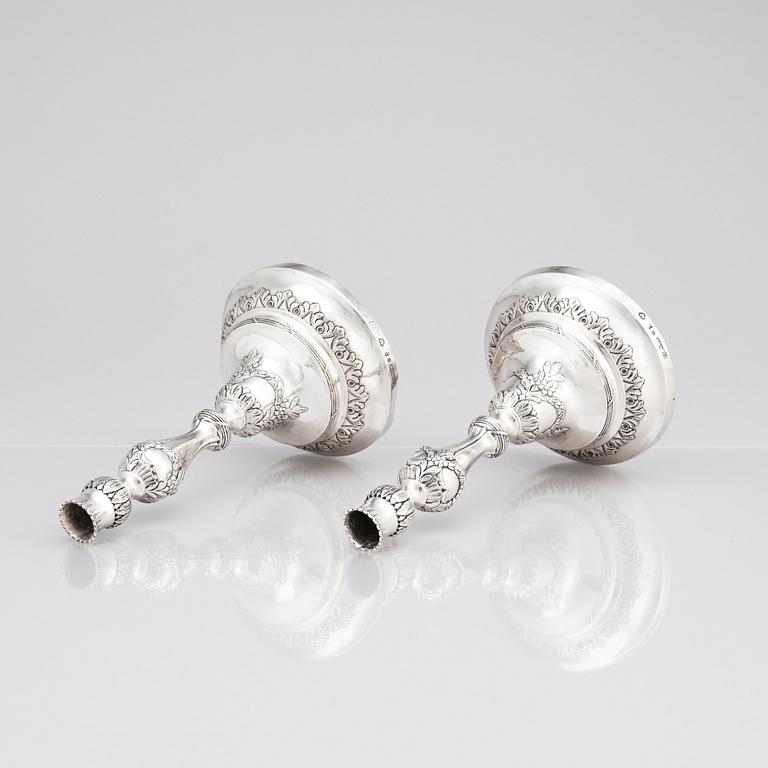 A pair of Swedish 18 century silver candelabras, mark of Lars Åkerblom Gävle 1775, arms by Christian Kullberg.