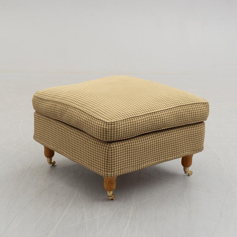 A foot stool by Fogia dressed in Ralph Lauren fabric.