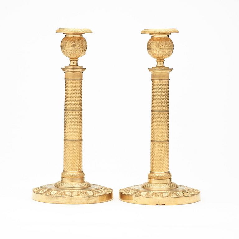 A pair of French Empire early 19th century candlesticks.