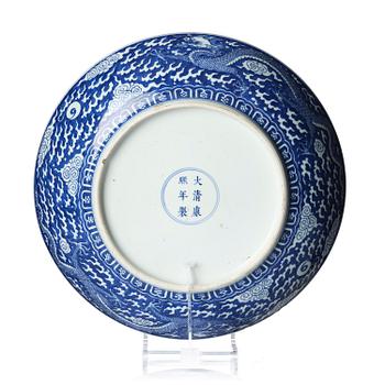 A rare large blue and white 'five clawed dragon' dish, Qing dynasty with Kangxi mark and of the preriod (1662-1722).