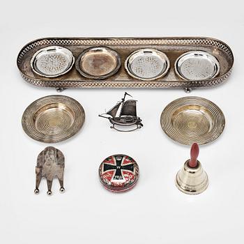 103. A table-bell, tray, ash-trays, snuff box, clip and a miniature-ship, silver plated and brass. 20th century.