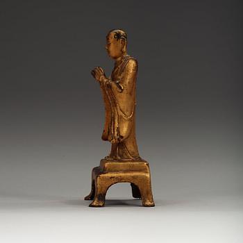 A lacquered gilt figure of a standing monk, Ming dynasty (1368-1644).