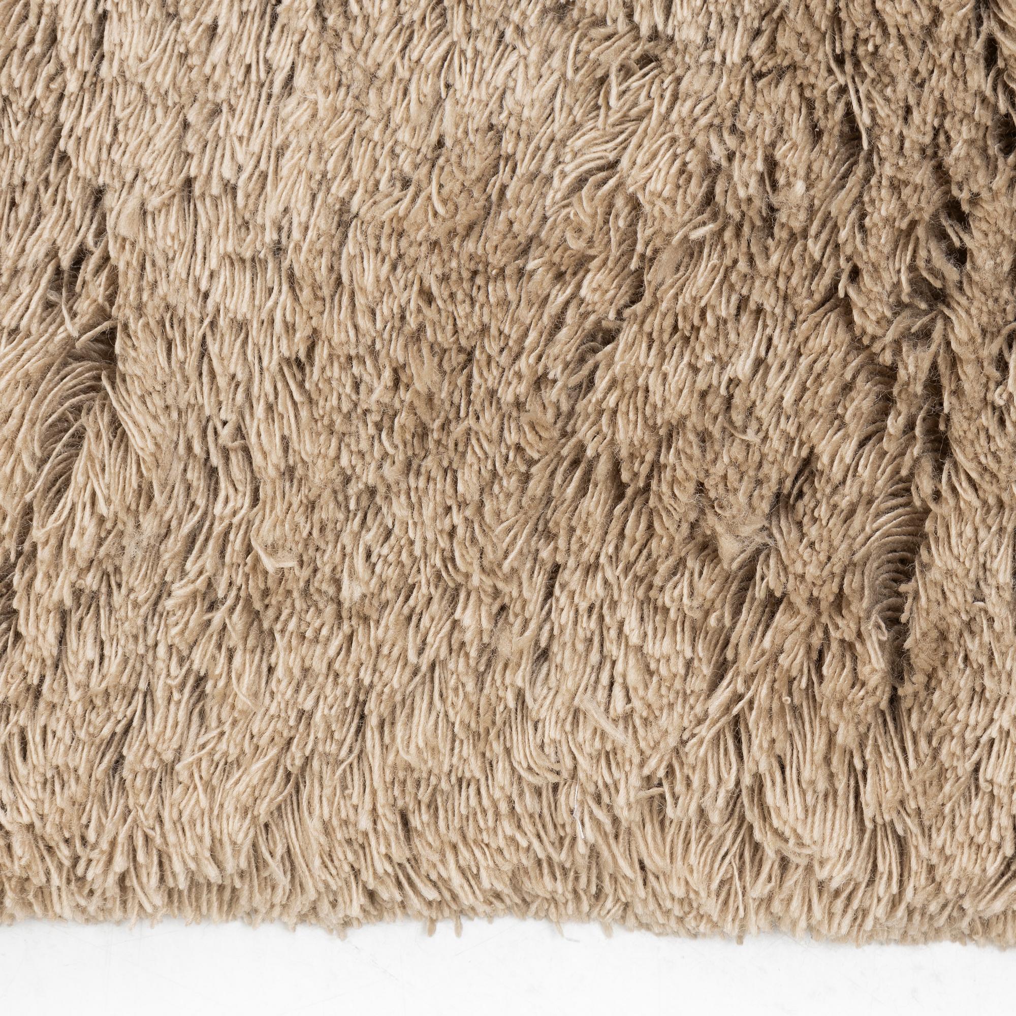 A monochrome carpet, 'Fallingwater - Mocha' by Layered, ca 400 x 300 cm.