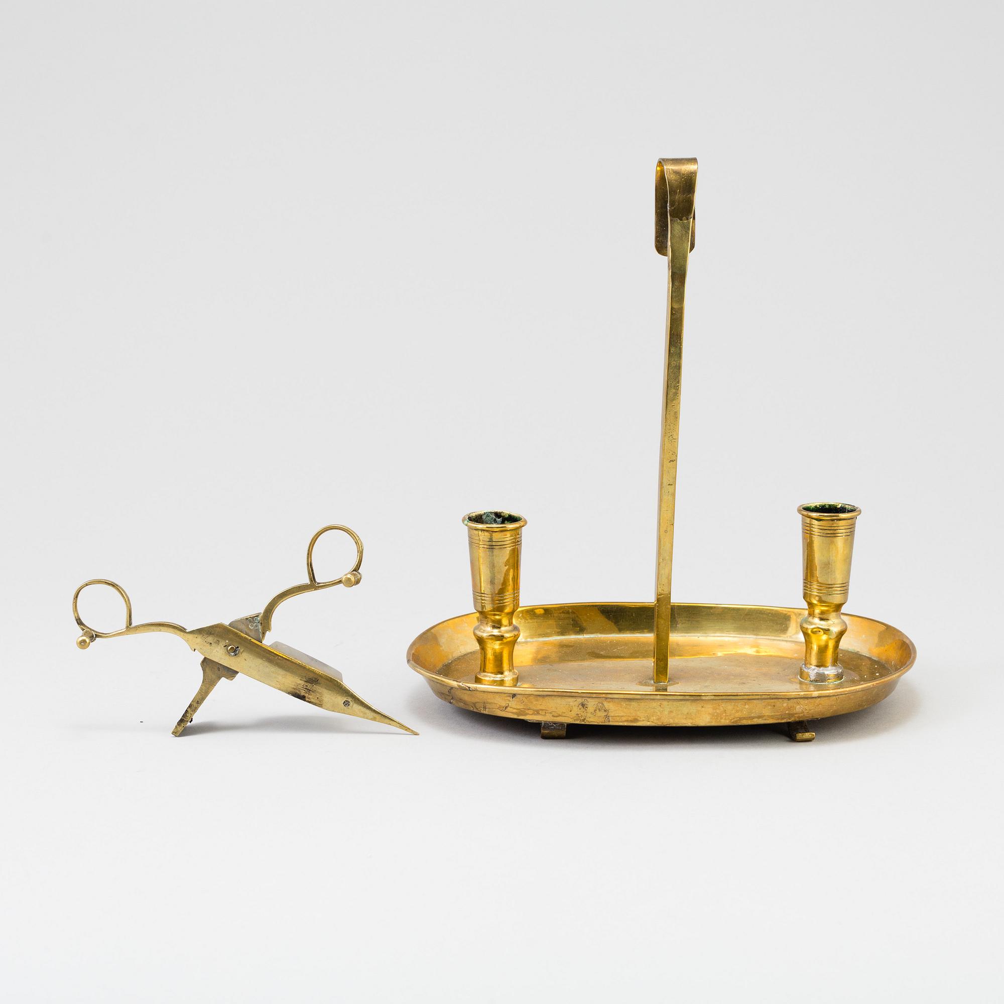 A 19th century bra candleholder for two candles and candle wick-trimming scissors.