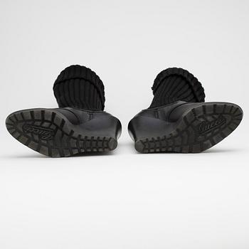 GUCCI, a pair of black leather boots.