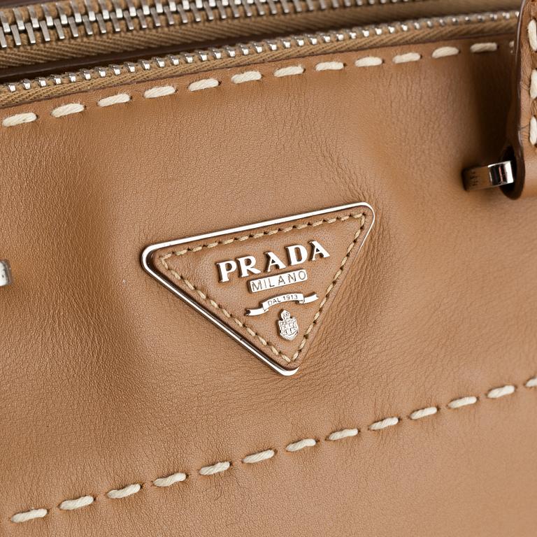 Prada, a leather handbag.