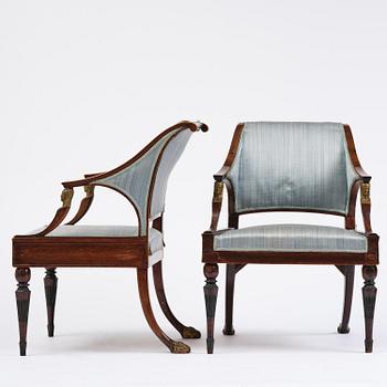 A pair of late Gustavian mahogny armchairs.