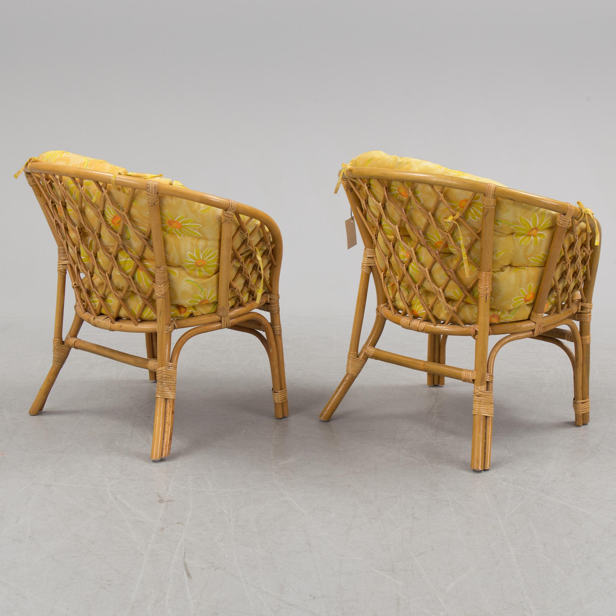 A 1970s four piece set of rattan garden furniture.
