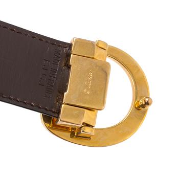 A black leather belt by Cartier.