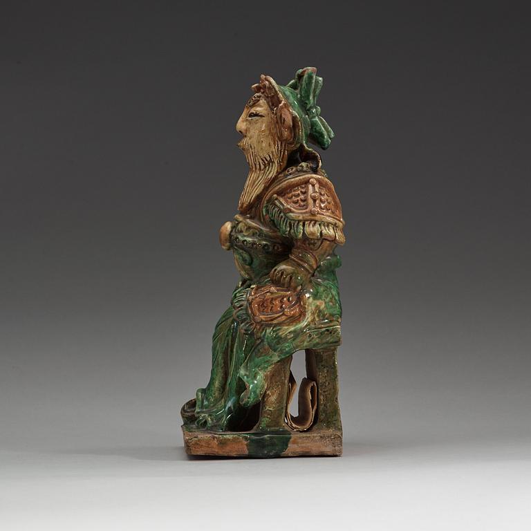 A green and yellow glazed roof tile figure of a warrior, Ming dynasty (1368-1644).