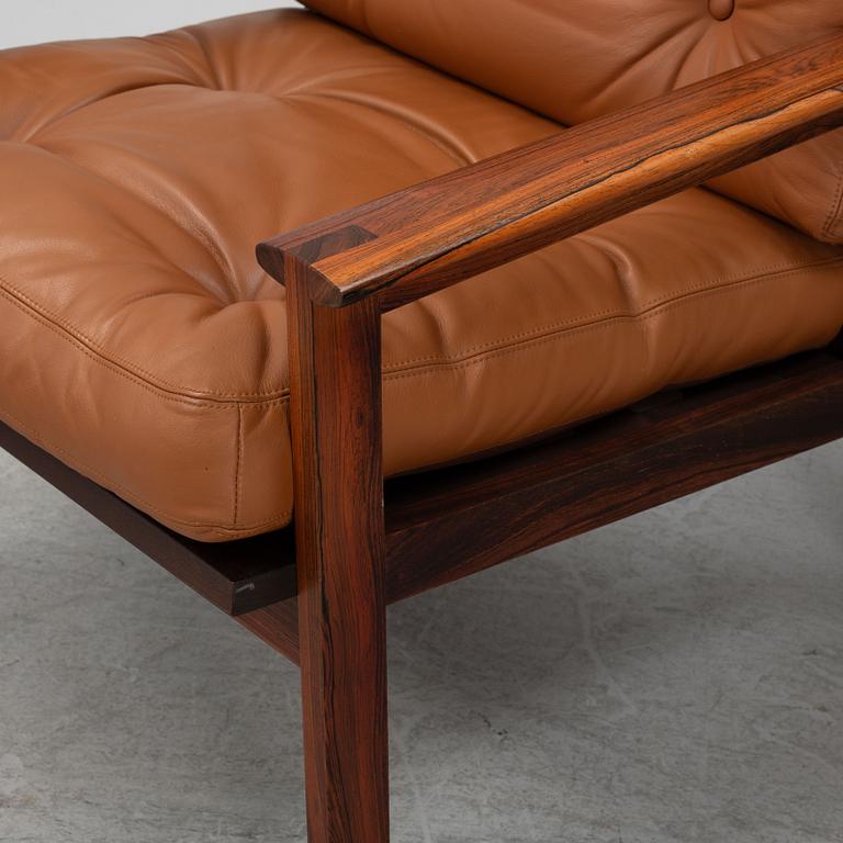 Illum Wikkelsö, a pair of 'Capella' armchairs and an ottoman, second half of the 20th century.