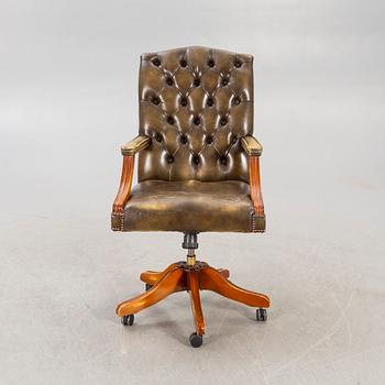 An English 21st century addjustable leather desk chair.