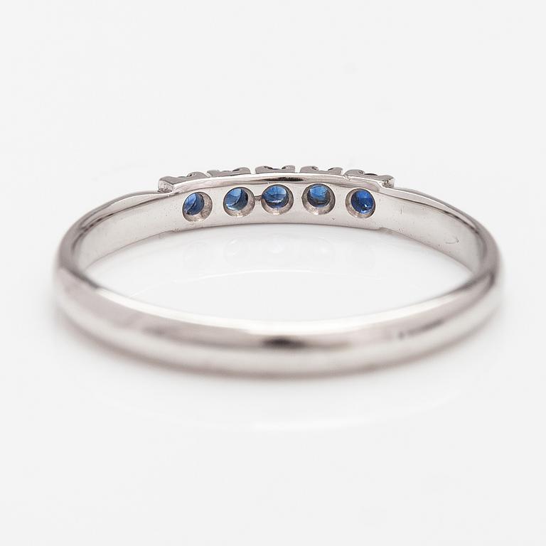 A 14K white gold ring with sapphires.