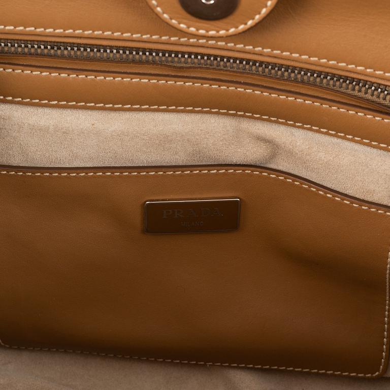 Prada, a leather handbag.