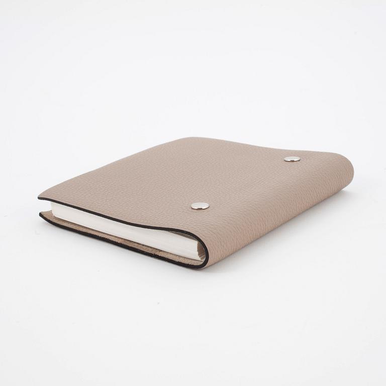 HERMÈS, a taupe veau togo leather notebook, "Ulysse Petit Modèle".